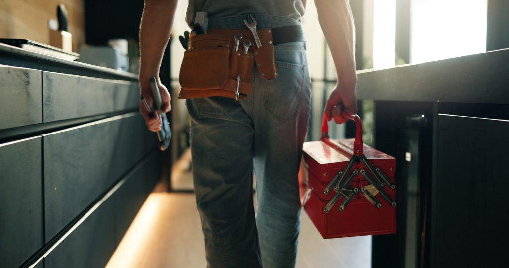 Plumber walking through a kitchen